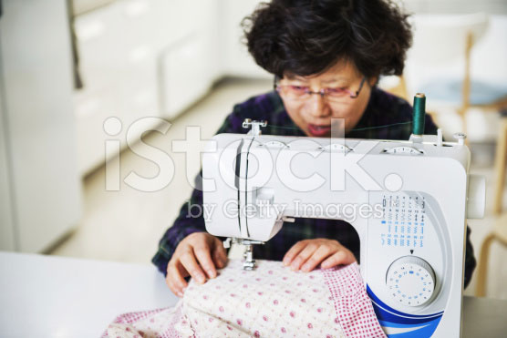 stock-photo-39744578-housewife-and-sewing-machine