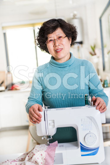 stock-photo-39823676-housewife-and-sewing-machine