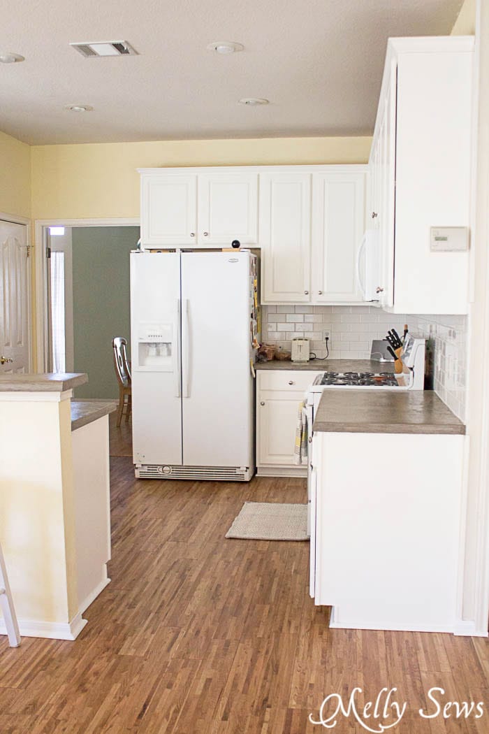 After - White cabinets, gray counters and hardwood floors - White Kitchen Makeover on a budget - DIY remodel from dull and dated to white and bright - Melly Sews