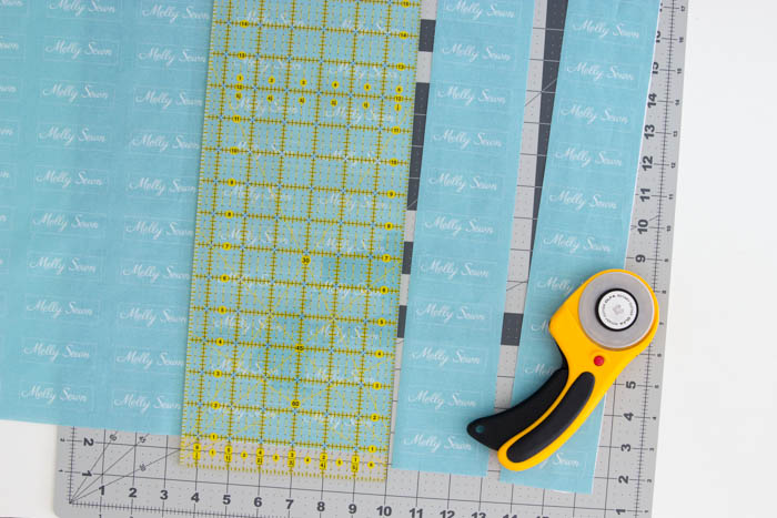 Rotary cutter, ruler and cutting mat to cut apart sew on clothing tags