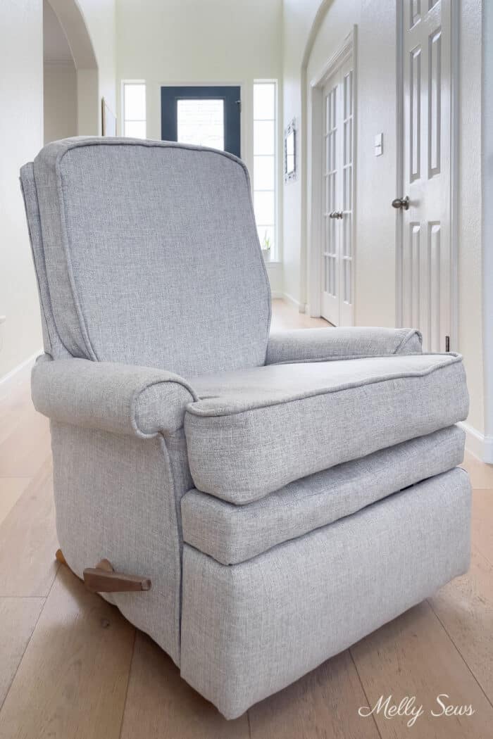 Reupholstered recliner in light gray fabric with detachable seat and seat back cushions