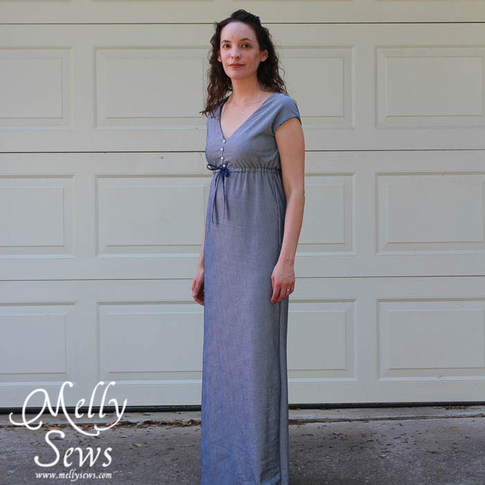 Woman in a floor length casual blue dress 