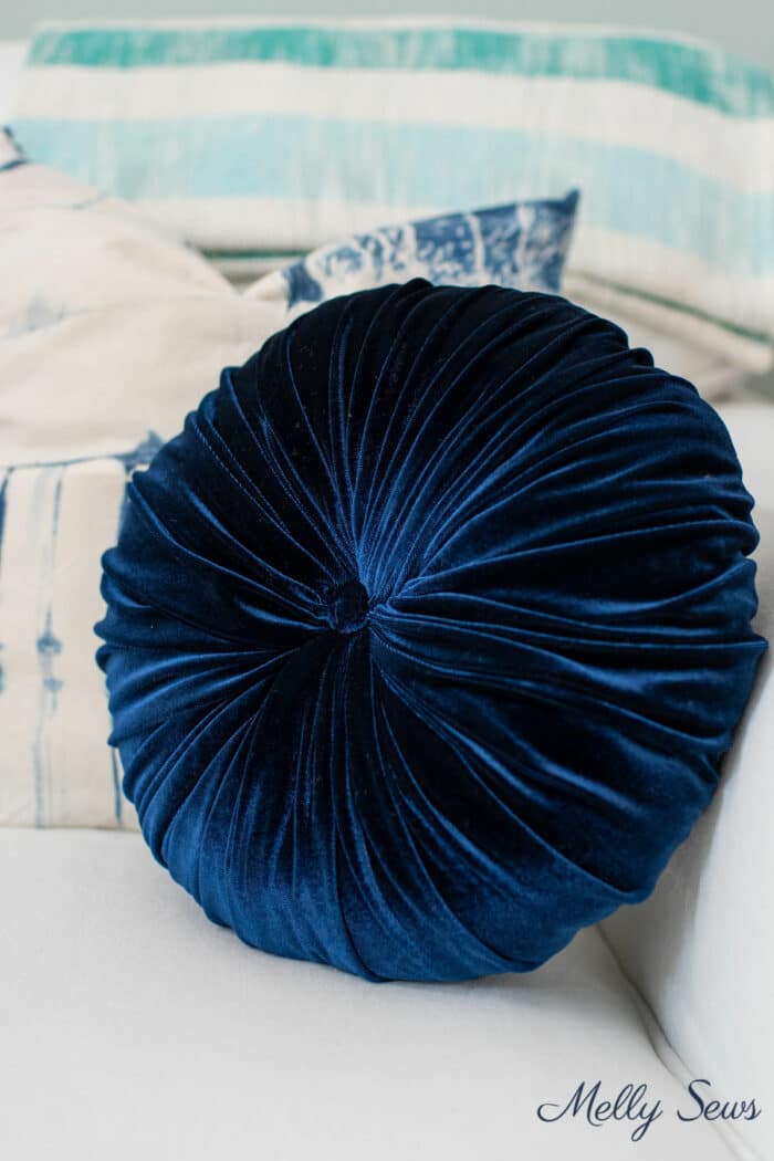 Dark blue round sofa pillow made by hand