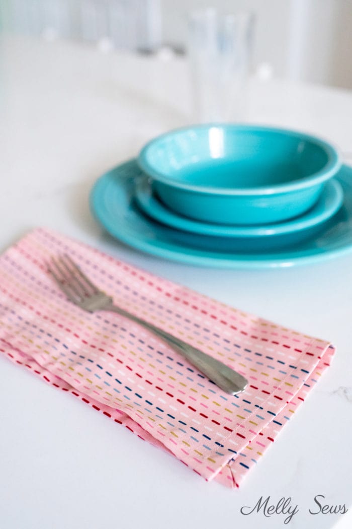 Re usable napkin with a fork and plate and bowl place setting