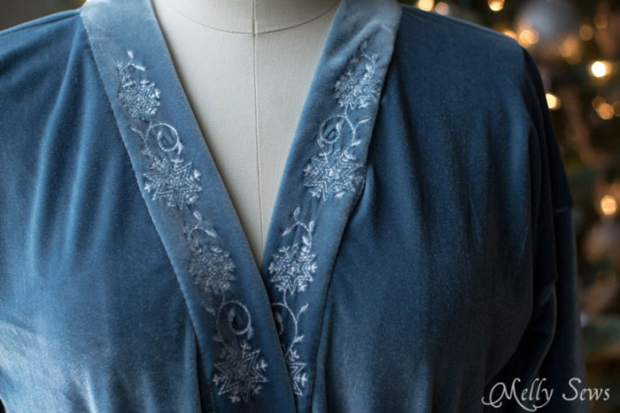 Close up - stretch velvet robe with snowflake embroidery on the band. 