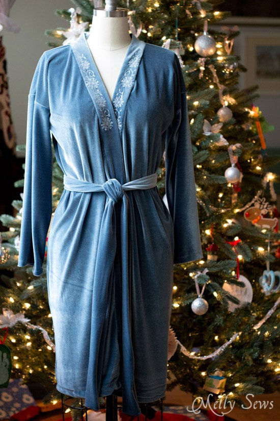 Full length view of a hand sewn stretch velvet robe in front of a Christmas tree