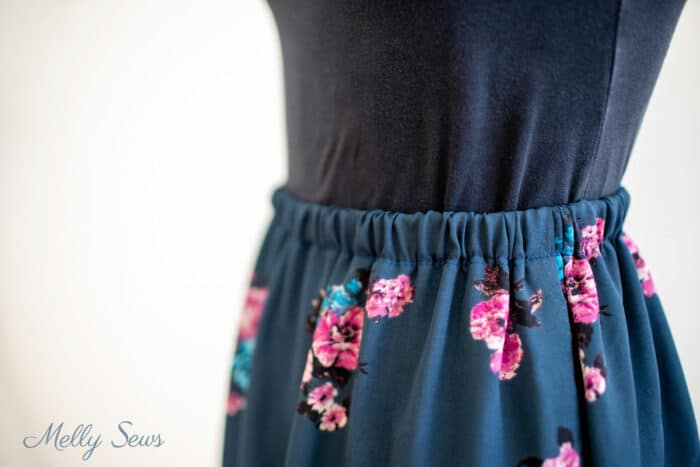 Close up of the elastic waistband of a blue floral skirt