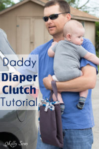 Man carrying a baby and a diaper clutch while getting into a car with text Daddy Diaper clutch tutorial