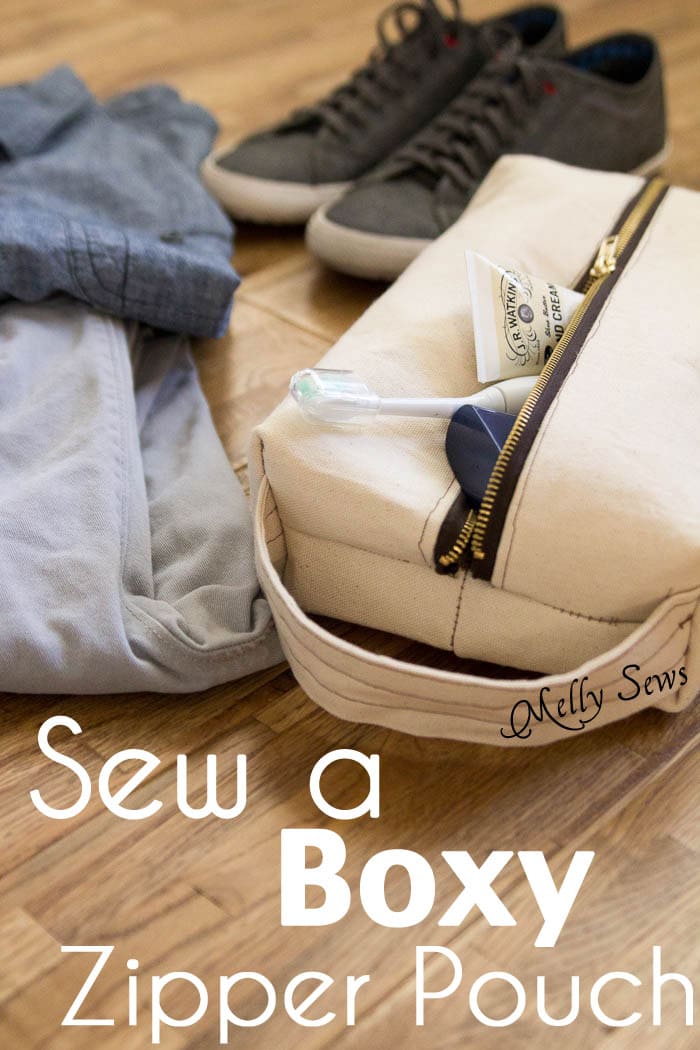 A canvas zippered boxy bag with toothbrush  sticking out and mens clothing and shoes in background with text Sew a Boxy Zipper Pouch