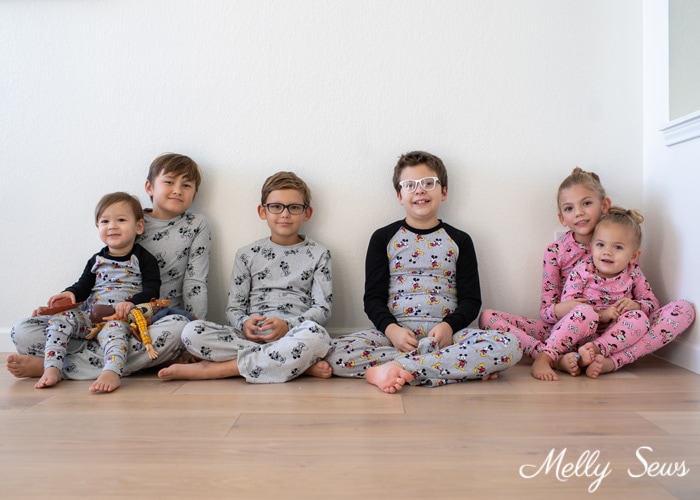 Coordinating pajamas on a group of kids - six sets of custom Mickey Mouse fabric pajamas sewn for cousins 