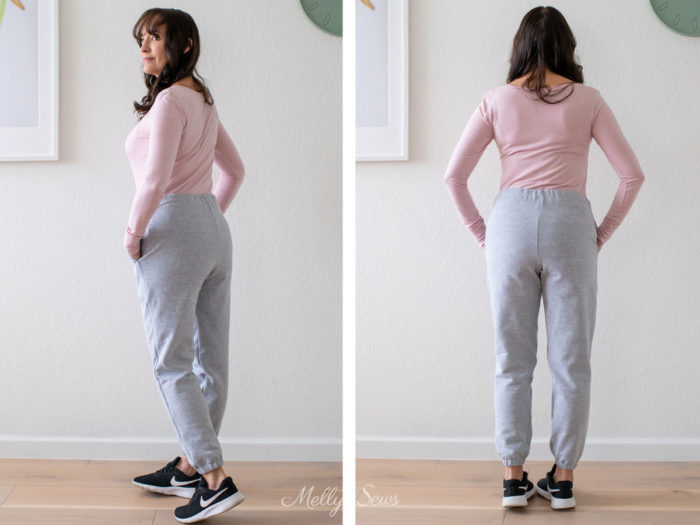 Side back and back view of a woman wearing a pink t-shirt and gray sweatpants outfit