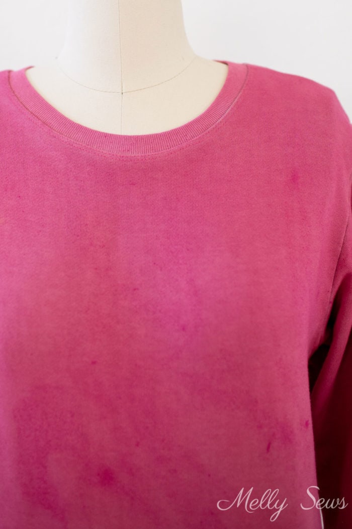 Close up of neckband on a pink sweatshirt