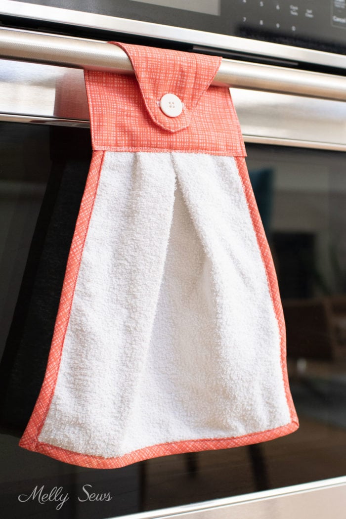 Home sewn kitchen towel hanging on the oven bar