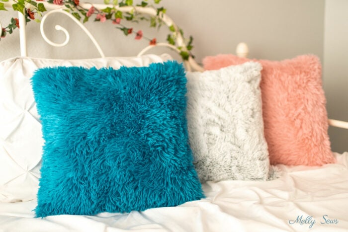 Girls daybed decorated with fur toss pillows