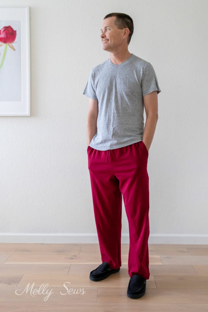 Man wearing gray t-shirt and dark red knit fabric pajama pants sewn at home