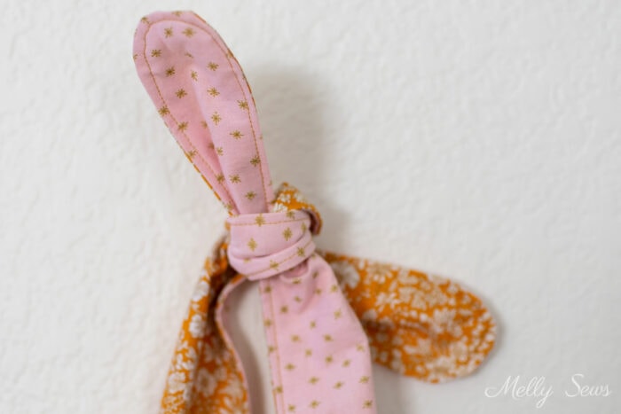 Knotted purse handle in pink and gold