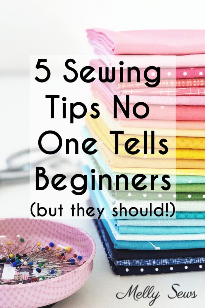 Stack of colorful folded fabric next to a magnetic pin tray with the text 5 Sewing Tips No One Tells Beginners (but they should!)