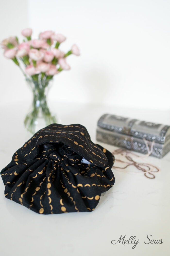 Black fabric cosmetics bag on a counter