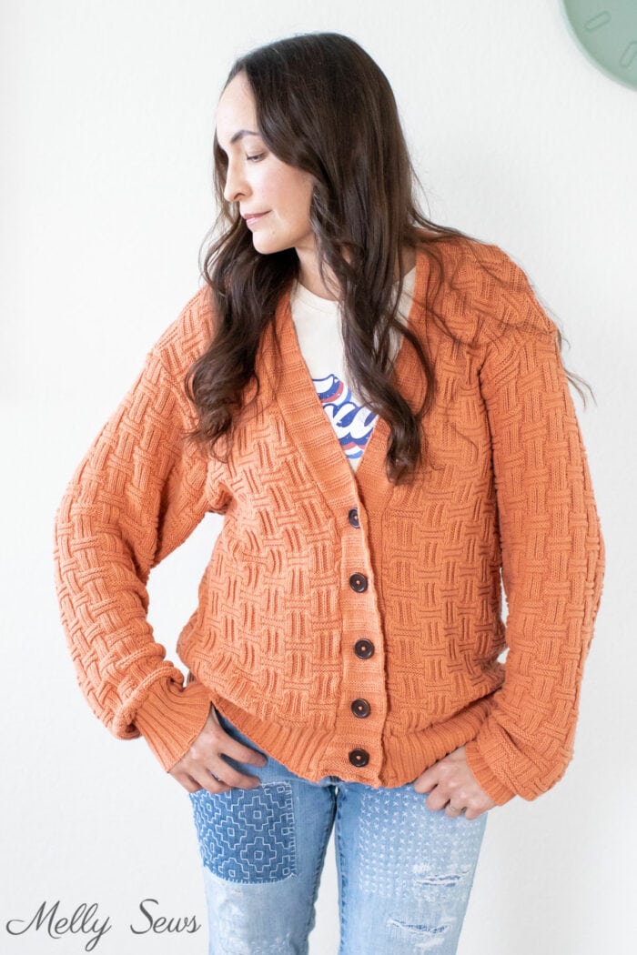Pumpkin colored cardigan sewn by the woman wearing it