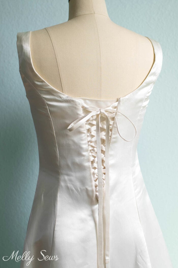 Corset lacing panels instead of a zipper on the back of a formal white dress