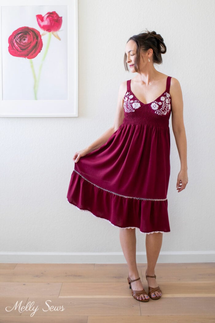 Brunette woman in a maroon embroidered sundress