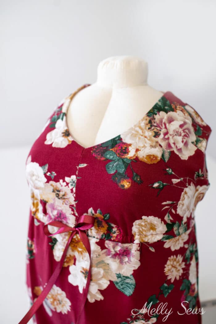 Red floral dress on a dress form