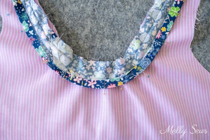 Bias binding unfolded and pinned to neckline
