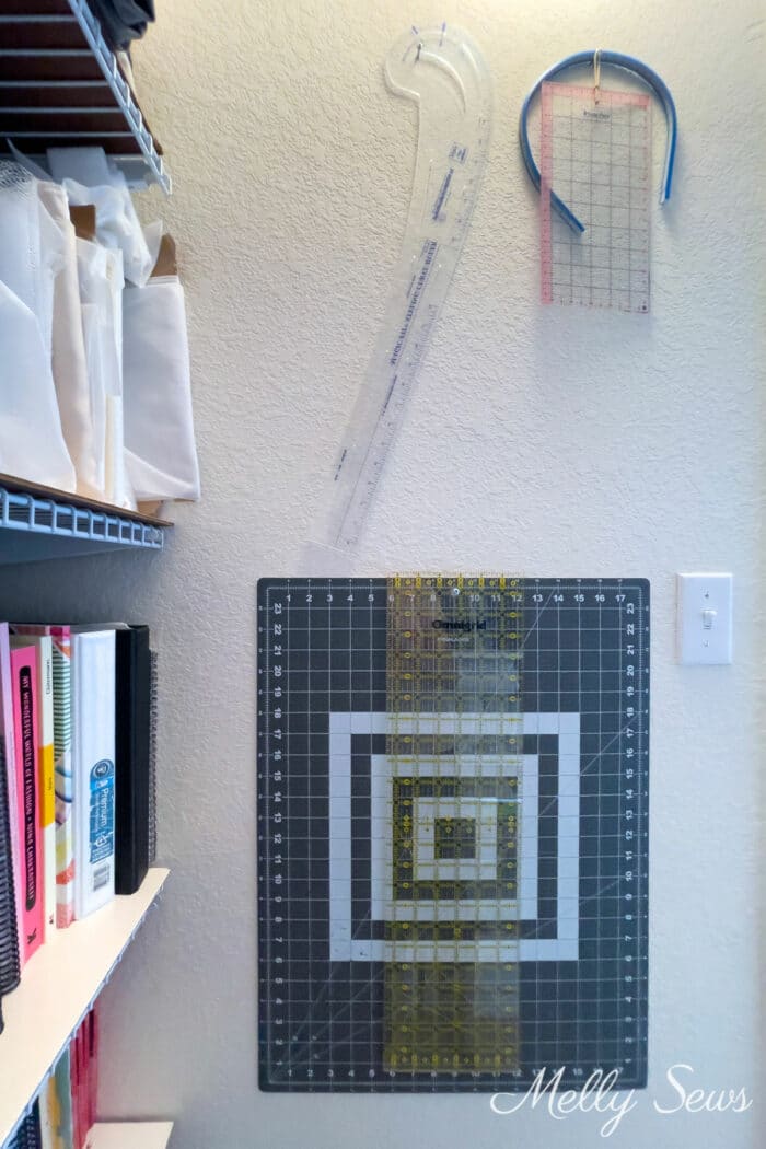 Sewing cutting mat and rulers hanging on a wall