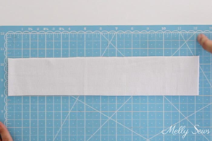 White rib knit neckband on a blue cutting mat