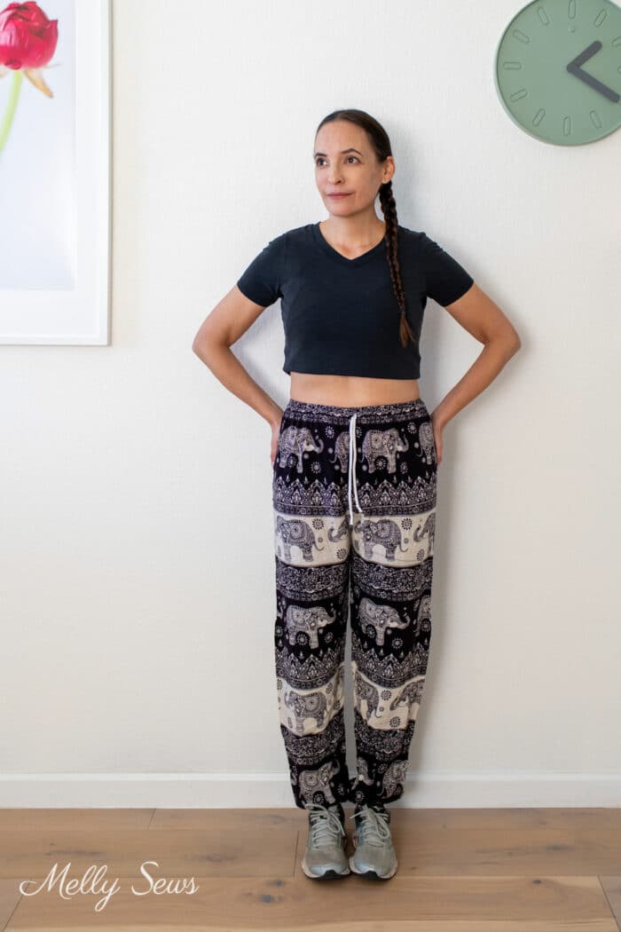 Woman in loose printed pants and black t-shirt