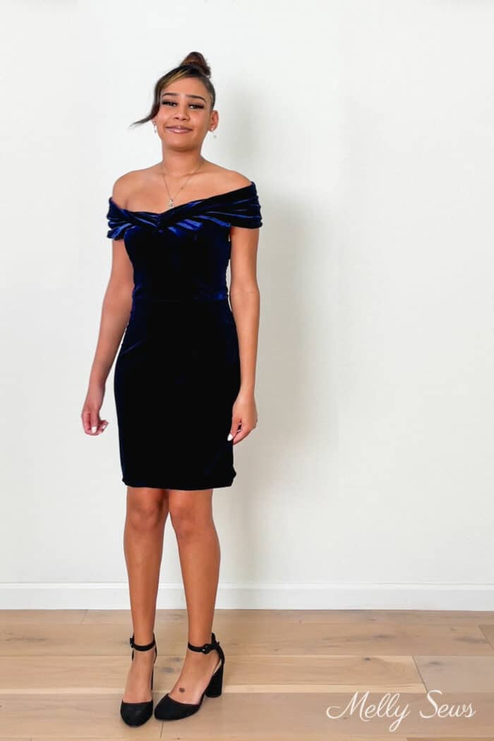 Young Black woman in a blue velvet dress she sewed alterations in