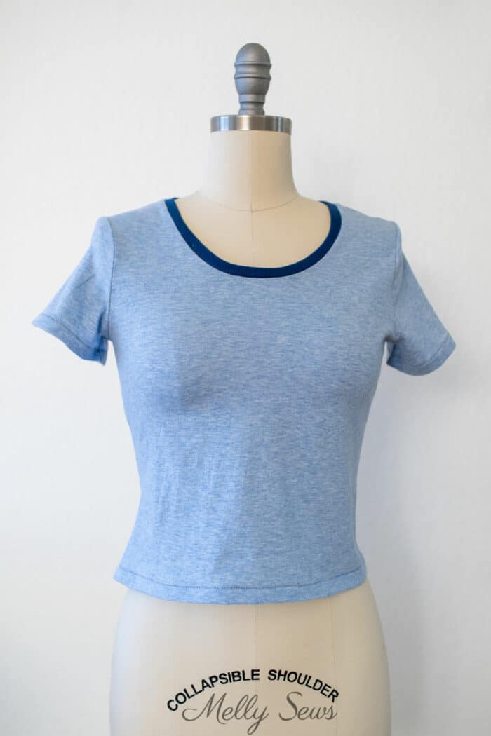 Dress form wearing a light blue t-shirt sewn using a serger
