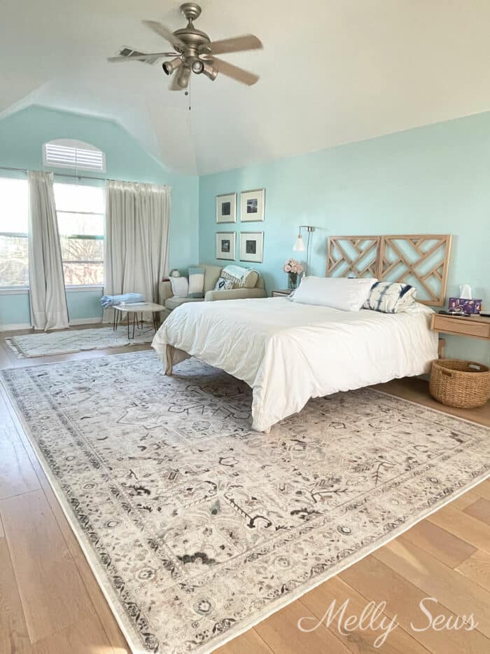 Pale aqua bedroom with an ivory persian patterned rug on the floor