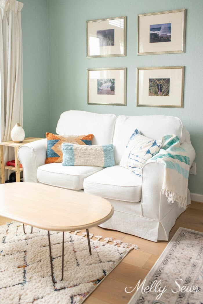White traditional loveseat against a blue wall