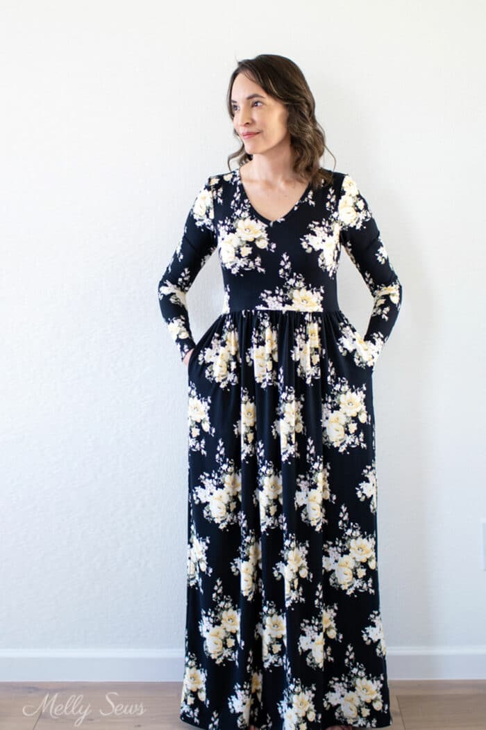 Woman in a black floral maxi dress with long sleeves that she sewed for herself