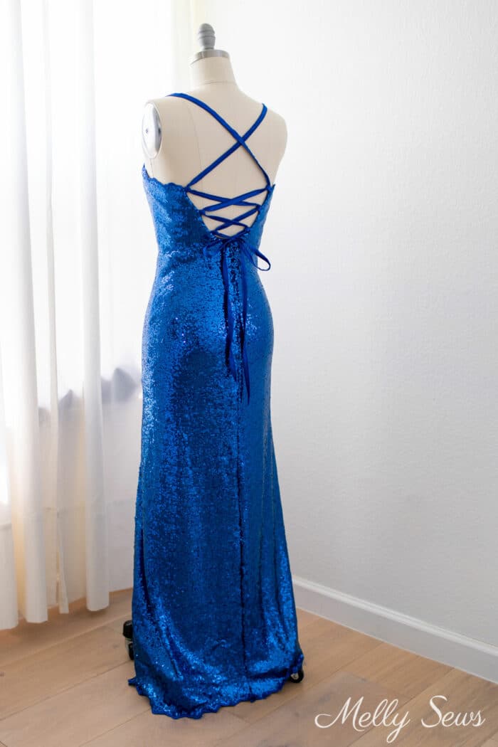 Back view of a full length formal dress with tie back