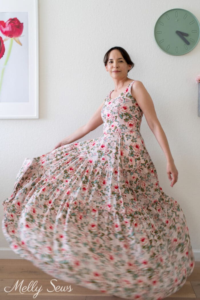 Woman twirling full skirt of a floral gown