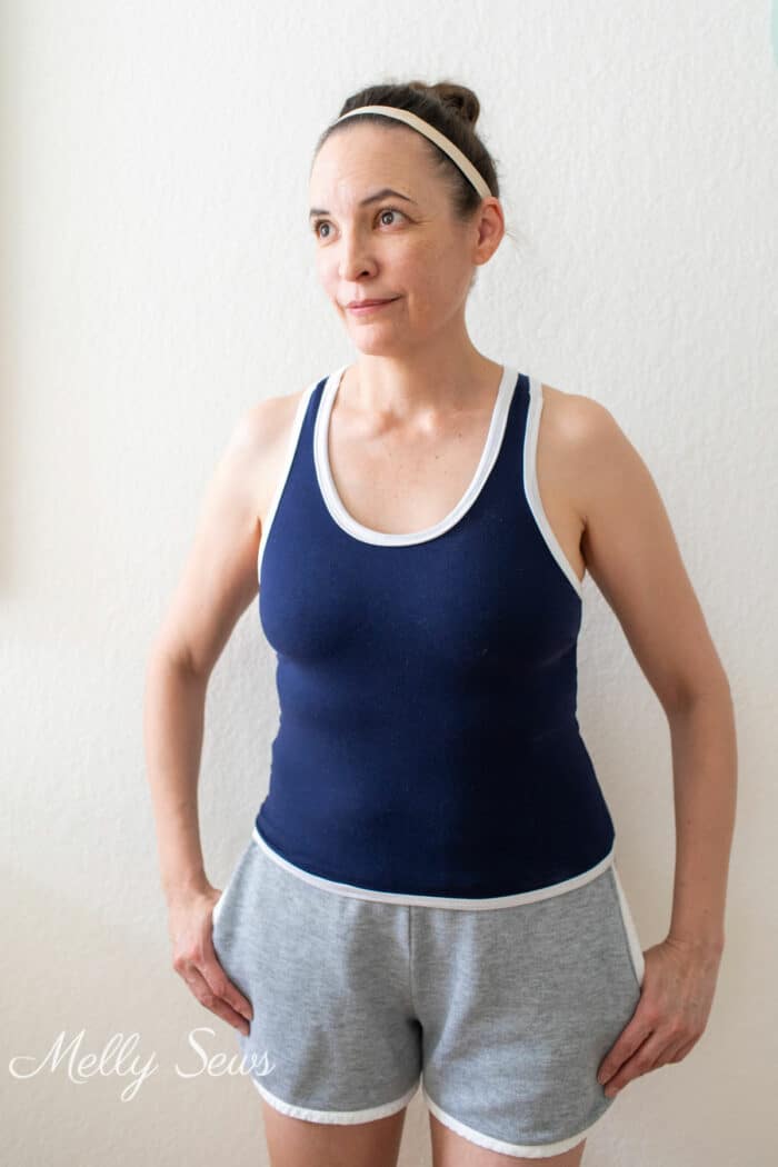 Woman in a blue tank top and gray shorts that she sewed for herself